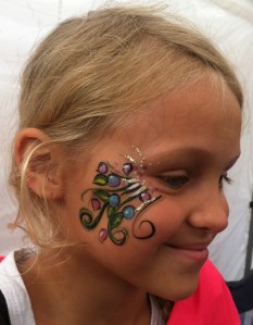 Blueberries! In honor of the festival theme. She came back later needing a touch-up...because she was in the pie eating contest! She even won it, and got more face paint. 