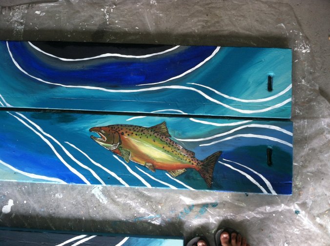 Sarah Glaser from Alaska of Sweet Roots Illustration paints raft for Kenai Riverdog company 