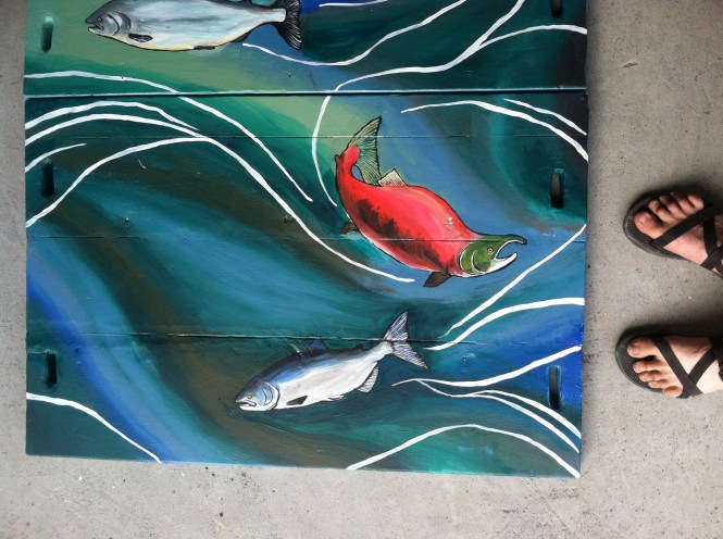 Sarah Glaser from Alaska of Sweet Roots Illustration paints raft for Kenai Riverdog company 